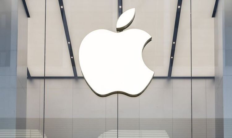 Large white Apple logo displayed on a modern glass storefront.