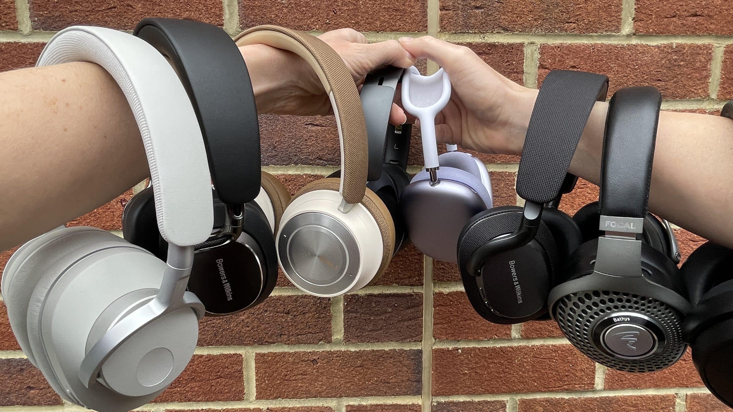 Collection of premium over-ear headphones held side by side.