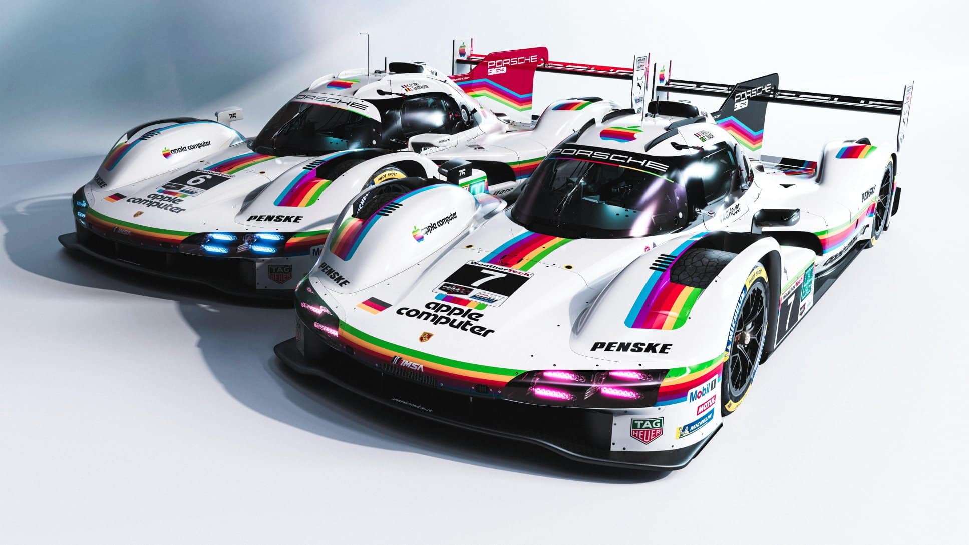 Two Porsche 963 race cars with retro Apple rainbow livery.