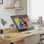 Alogic Aspekt Touch monitor displaying digital artwork on a modern desk setup.