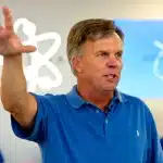 Ron Johnson speaking and gesturing during an event in an Apple Store.