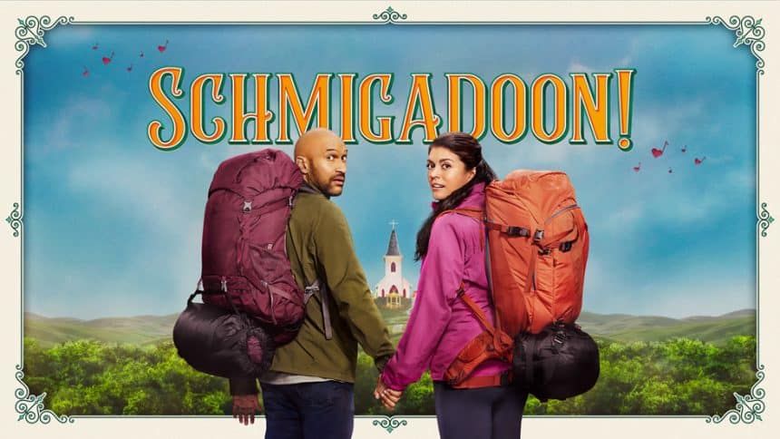 Promotional poster for Schmigadoon! featuring two hikers with backpacks standing in front of a colourful countryside backdrop.