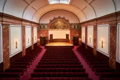 Interior view of Wigmore Hall with red seats and a concert stage.