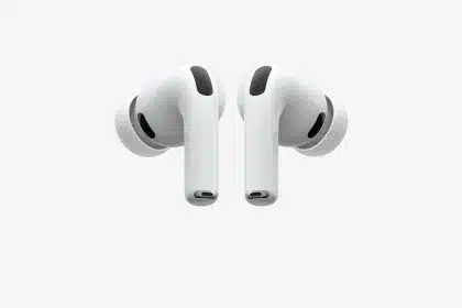 Apple AirPods Pro wireless earbuds with silicone ear tips on a gray background.