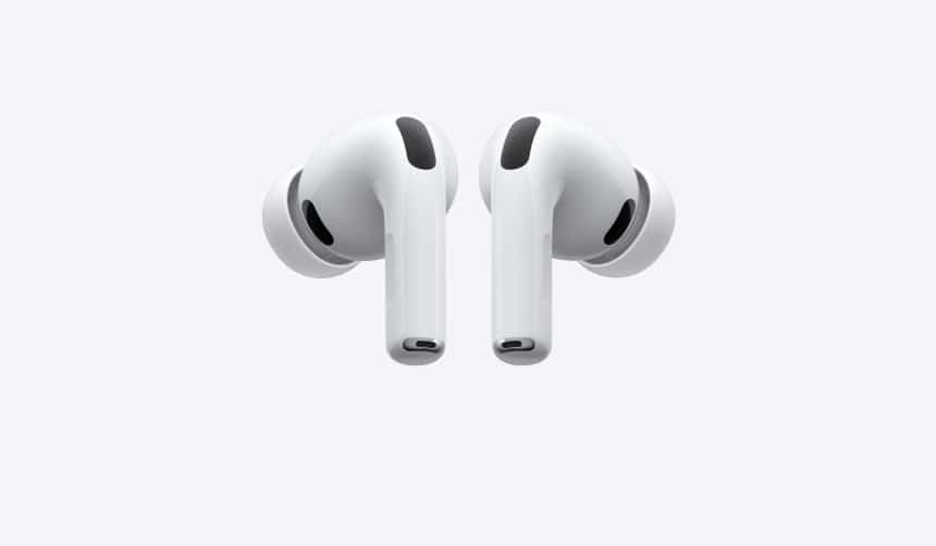 Apple AirPods Pro wireless earbuds with silicone ear tips on a gray background.