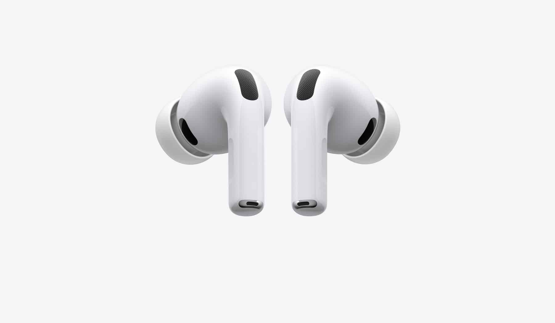 Apple AirPods Pro wireless earbuds with silicone ear tips on a gray background.