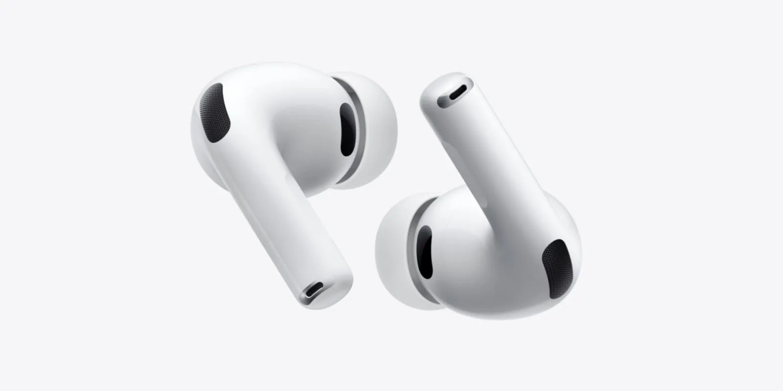A pair of white Apple AirPods wireless earbuds on a light gray background.