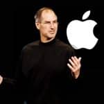 Steve Jobs presenting on stage with an Apple logo displayed behind him.
