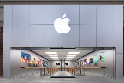 Apple Store entrance with a large illuminated Apple logo above the storefront.