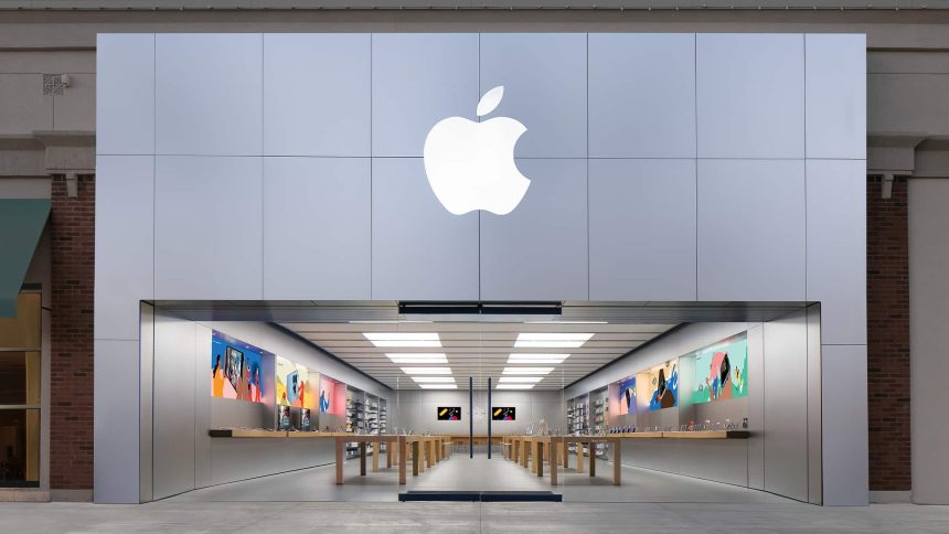 Apple Store entrance with a large illuminated Apple logo above the storefront.