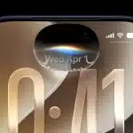 Close-up of an iPhone screen showing the iOS 27 lock screen and Dynamic Island interface.