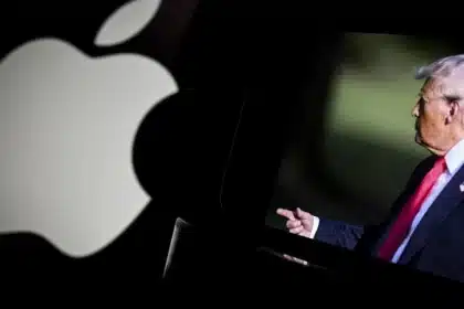 Apple logo beside a screen displaying U.S. President Donald Trump.