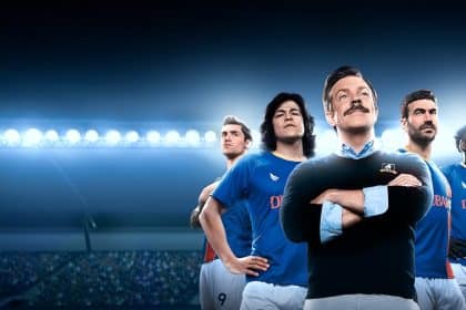 Ted Lasso and AFC Richmond team members in a stadium.