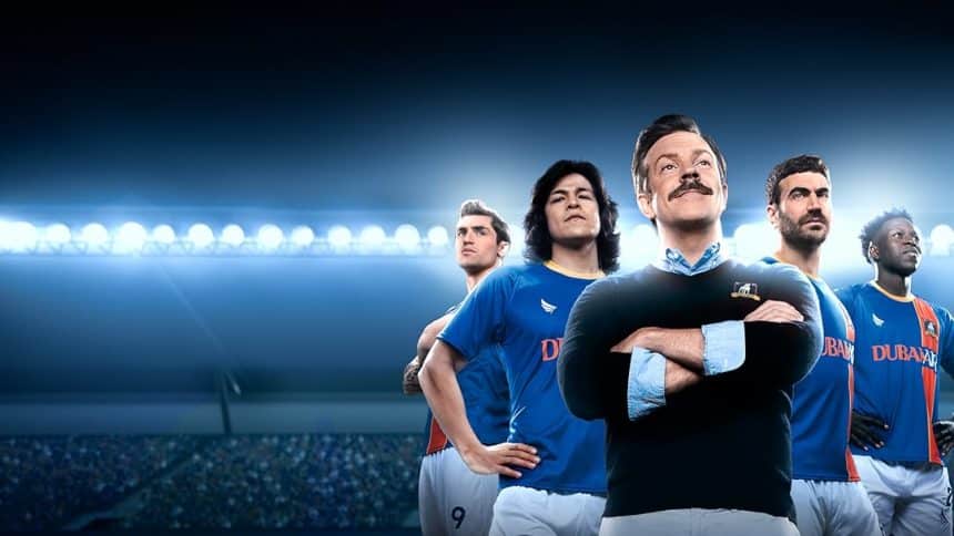 Ted Lasso and AFC Richmond team members in a stadium.