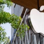Apple logo displayed outside an Apple Store building.