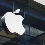 Apple logo displayed on the glass exterior of an Apple Store.