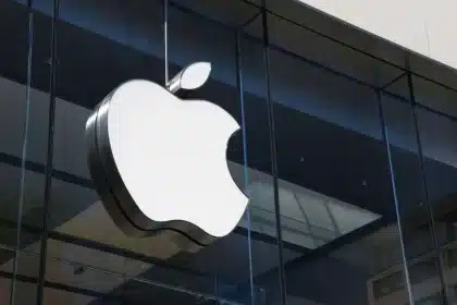 Apple logo displayed on the glass exterior of an Apple Store.
