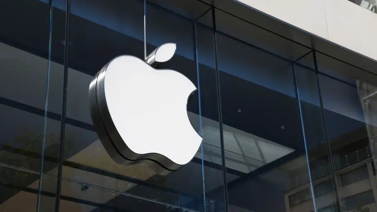 Apple logo displayed on the glass exterior of an Apple Store.