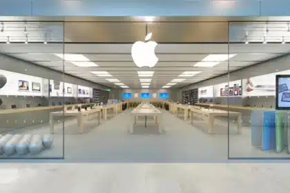 Apple Store interior with product displays and a large Apple logo.