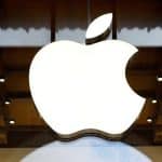 Large illuminated Apple logo displayed inside a store.