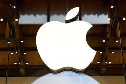 Large illuminated Apple logo displayed inside a store.