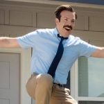Ted Lasso celebrating with his arms raised.
