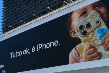 Apple billboard in Milan showing a child holding a food-covered iPhone.
