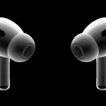 Apple AirPods Pro earbuds on a black background.