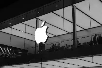 Apple logo displayed on a glass-fronted Apple Store.