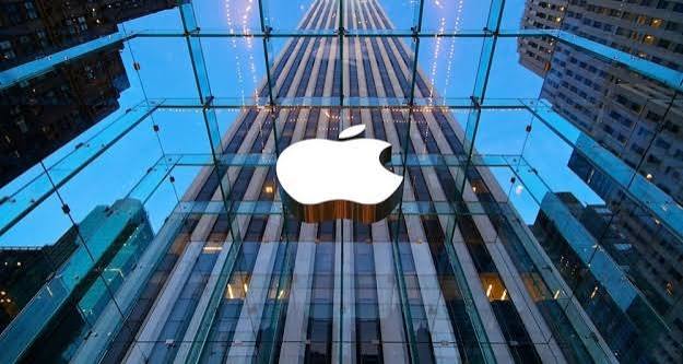 Apple logo displayed on a glass-fronted building.