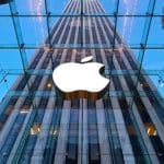 Apple logo displayed on the glass front of an Apple Store.