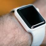 White ceramic Apple Watch on a person's wrist.