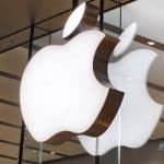 Illuminated Apple logos displayed inside an Apple Store.