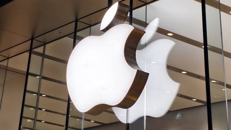 Illuminated Apple logos displayed inside an Apple Store.
