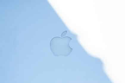 Apple logo displayed on a light blue surface.