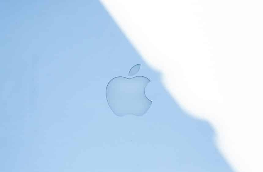 Apple logo displayed on a light blue surface.