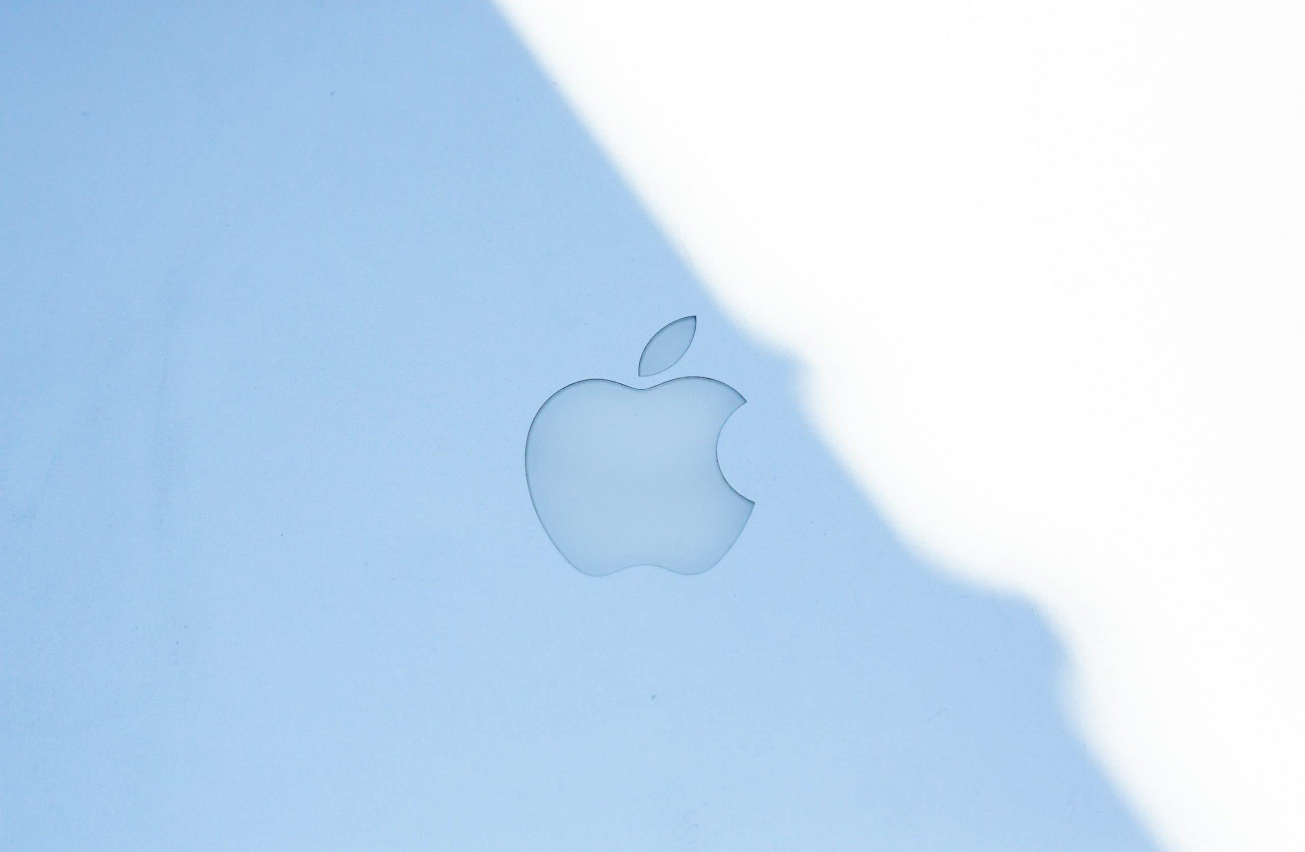 Apple logo displayed on a light blue surface.