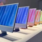 Colourful Apple iMacs displayed in a row.