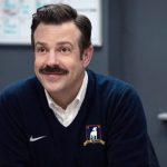 Ted Lasso smiling in an AFC Richmond sweater.