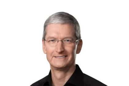 Portrait of Tim Cook smiling against a white background.