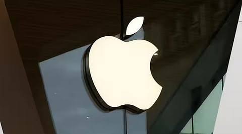 Illuminated Apple logo outside a store.