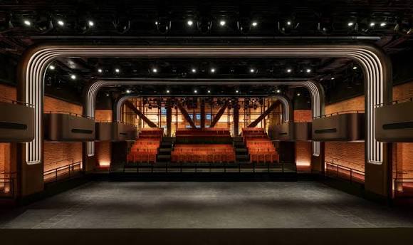 Interior of Apple Music Hall in London, featuring a stage and tiered seating.