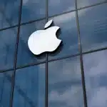 Apple logo displayed on a glass building.