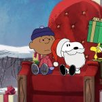Snoopy, Charlie Brown, and Woodstock sitting beside Christmas presents.