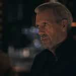 A man in a dark suit from Apple TV’s Wanted Man.