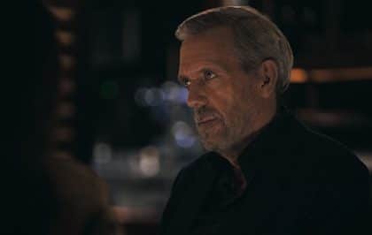 A man in a dark suit from Apple TV’s Wanted Man.