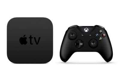 Apple TV device beside a black gaming controller.