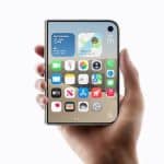 Hand holding an iPhone Duo with apps displayed.
