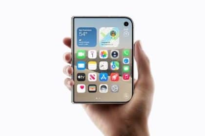 Hand holding an iPhone Duo with apps displayed.
