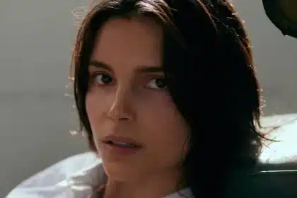 Close-up of a dark-haired woman looking toward the camera.